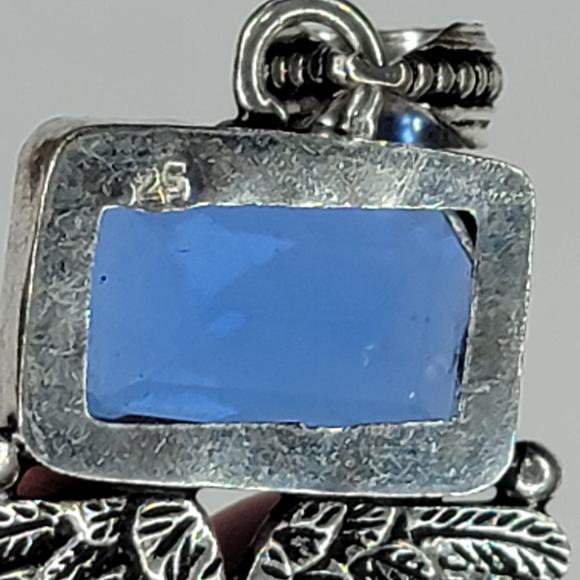 Sterling Silver Pendant with Brown Carved Face, Blue Topaz, and Feather Motif - Picture 5 of 13